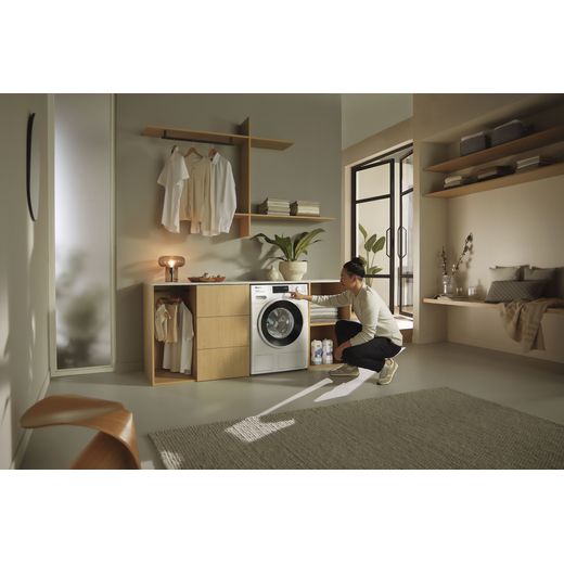 Miele W1 PowerWash & TwinDos WSG883 WCS 8kg Washing Machine with 1600 rpm - White - Women using washing machine shot